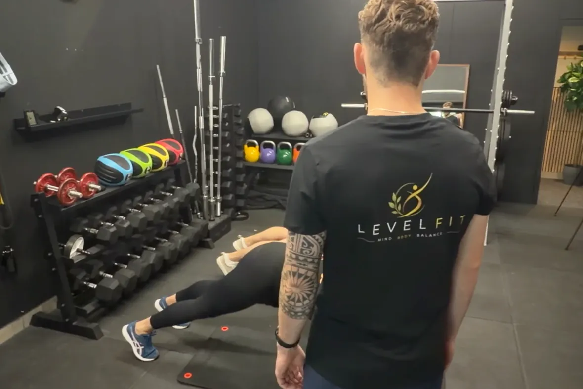 Trainer begeleidt een oefening in de studio van LevelFit Enschede